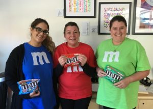 3 staff dressed as M and Ms