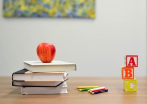 apple on books on desk